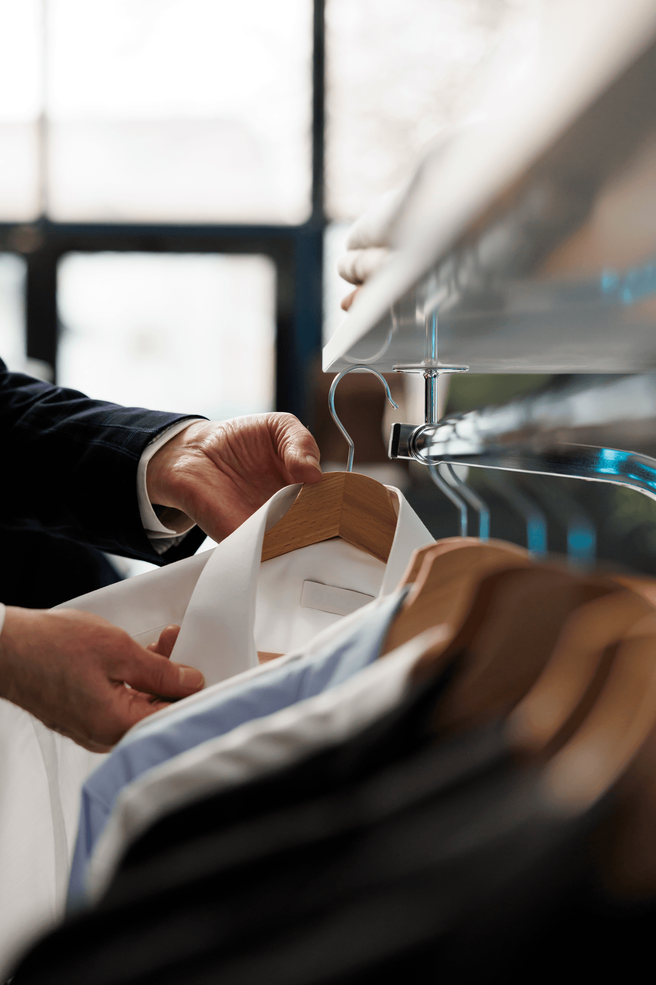 Selecting freshly cleaned shirts at Nova Klean, Tulse Hill